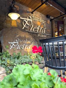 a black chair sitting in front of a restaurant at Hotel Giardino Di Pietra in Gramado