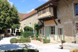 a building with a balcony on the side of it at La Dominotte in Demigny