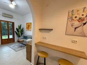a living room with a painting of a woman on the wall at NIVAS Apartment Pefkochori in Pefkochori