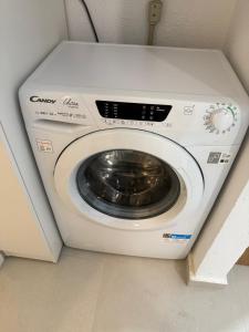 a white washing machine in a small room at NIVAS Apartment Pefkochori in Pefkochori