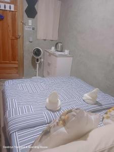 a bedroom with two beds with towels on them at Secret Room Bliss in Baguio