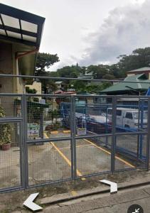 a gate with arrows pointing into a parking lot at Secret Room Bliss in Baguio