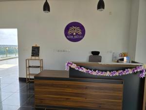 a counter with purple flowers on it in a restaurant at ADM HOTEL Grand-Lahou in Grand-Lahou