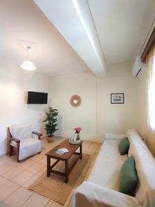 a living room with a couch and a table at Myrstia Apartments in Pyrgi Thermis