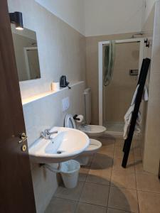 a bathroom with a sink and a toilet and a shower at Corte Meneghina-short stays in Buscate