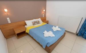 Ένα ή περισσότερα κρεβάτια σε δωμάτιο στο Eleni Palace 