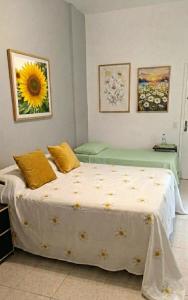 a bedroom with a bed with a sunflower on it at Studio Catete Flamengo in Rio de Janeiro