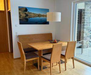 a dining room with a wooden table and chairs at Alpin Park Matrei in Matrei in Osttirol