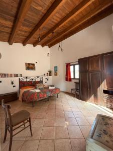 a bedroom with a bed and a table and chairs at Terrazza delle mura in Cefalù