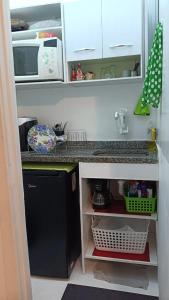 a kitchen with a counter top and a refrigerator at Studio Catete Flamengo in Rio de Janeiro