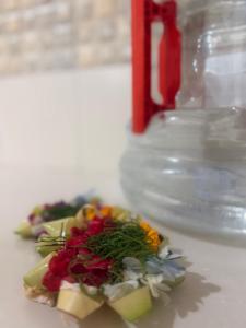 a plate of food with flowers on a table at Rahayu House in Kusamba +23 photos
