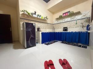 a kitchen with red shoes on the floor at Rahayu House in Kusamba