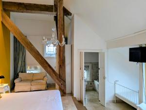 a bedroom with a bed and a couch in a room at Boutique Hotel Westerlee in Westerlee