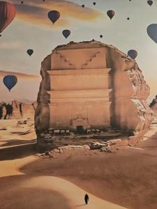 a painting of hot air balloons flying over a pyramid at Al Seef Hotel in Al-ʿUla