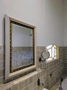 a bathroom with a mirror and a sink at Boutique Hotel Westerlee in Westerlee +17 photos