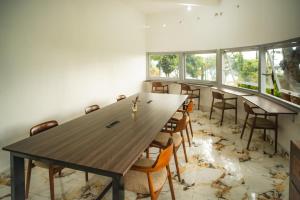 a conference room with a long wooden table and chairs at Comuna Tigabelas in Gisi +8 photos