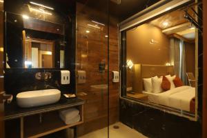 a bathroom with a shower and a sink and a mirror at The Udit By West Western - Central Heated and Air Cooled - River View & Roof Top cafe & Bar in Kasol