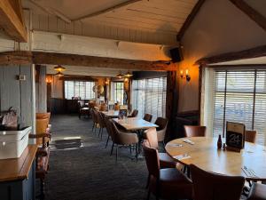 a dining room with wooden tables and chairs at Quality City Hotel Restaurant Free Parking in Upton Warren