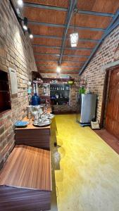 a kitchen with a counter and a brick wall at AV Meadows in Kanchipuram