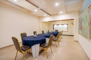 a conference room with tables and chairs and a whiteboard at Treebo Twin Tree Residency in Gurgaon +32 photos