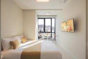 a bedroom with a bed and a large window at Gem Stay Seomyeon in Busan
