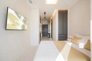 a bedroom with a bed and a tv on a wall at Gem Stay Seomyeon in Busan +40 photos