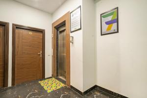 a hallway with a door and a colorful rug on the floor at Treebo Twin Tree Residency in Gurgaon