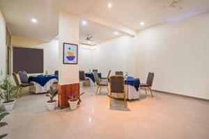 a meeting room with tables and chairs and a chalkboard at Treebo Twin Tree Residency in Gurgaon