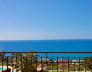 a view of the ocean from the balcony of a resort at PNOẼ Luxury Apartments in Lourdata