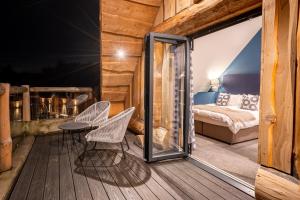 a room with a balcony with a bed and a table and chairs at The Lookout in Ilkley