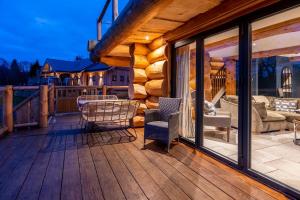 a wooden deck with a couch and chairs on it at The Lookout in Ilkley