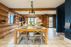 a dining room with a wooden table and chairs at The Lookout in Ilkley
