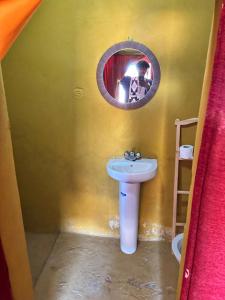 a person taking a picture of a bathroom with a sink at Chigaga Luxury Camp in Mhamid