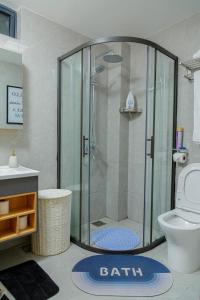 a bathroom with a shower and a toilet at Riara One Residency in Gatunga