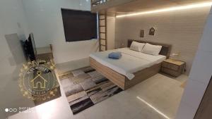 a bedroom with a bed and a television in it at Max Hostel in Can Tho