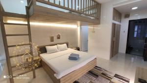 a bedroom with a bed in a room with a staircase at Max Hostel in Can Tho +104 photos