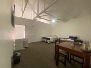a room with a room with two beds and a table at Fiet Star in Midrand