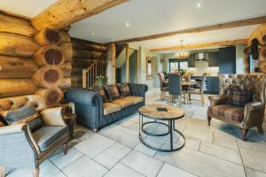 a living room with couches and a table at Keepers Cabin in Ilkley