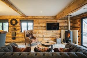 a living room with a couch and a fireplace at Keepers Cabin in Ilkley