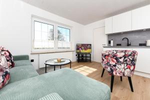 a living room with a couch and a table at Ferienwohnung Sternstunde in Bensersiel