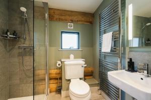 a bathroom with a toilet and a shower and a sink at Keepers Cabin in Ilkley +20 photos