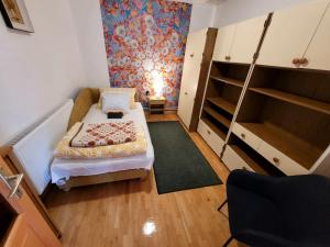a small room with a bed and a staircase at Mandula Apartman in Szeged