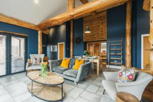 a living room with blue walls and wooden beams at The Farmhouse in Ilkley +24 photos