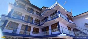 a blue and white building with balconies on it at Hotel Kailash View, Kalpa in Kalpa