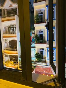 a view of a building through a window at Heaven Hostel in Ho Chi Minh City
