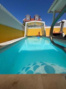 a swimming pool with a person in the background at The Throne in Alcabideche