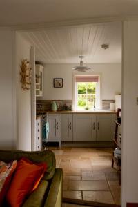 a kitchen with a couch and a window in it at Evrabister, Shetland Islands in Mainland