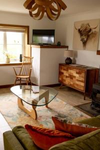 a living room with a couch and a glass table at Evrabister, Shetland Islands in Mainland +33 photos