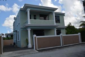 a blue house with a fence in front of it at Airways Residence in Plaine Magnien