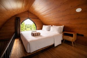 a large bed in a room with a window at Nirvana Hotel Resort Tetebatu in Tetebatu +45 photos